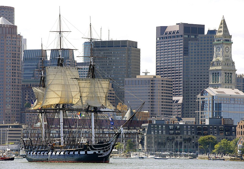 
              FILE - In this Aug. 29, 2014, file photo, the USS Constitution is towed through Boston Harbor past Boston's financial district skyline with its topsails unfurled. The warship nicknamed Old Ironsides, the world's oldest commissioned ship still afloat, is nearing the end of a two-year restoration in dry dock at the Charlestown Navy Yard. It is slated to return to the waters in late July 2017. (AP Photo/Stephan Savoia, File)
            