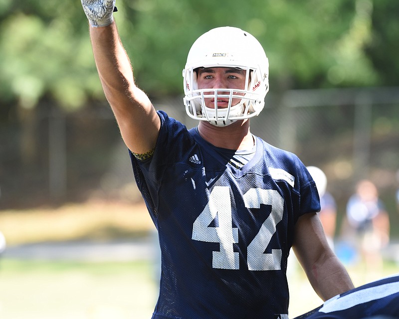 Defensive player Hawk Schrider points attention to a fellow player on the first day of Mocs football practice at Scrappy Moore Field.
