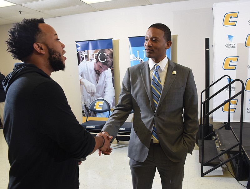 Steve Cook, left, meets new Mocs basketball coach Lamont Paris at the University of Tennessee at Chattanooga on Tuesday.