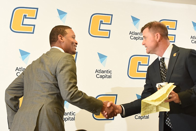 Lamont Paris, left, is introduced by Athletic Director David Blackburn as the new Mocs basketball coach at the University of Tennessee at Chattanoogaon Tuesday.