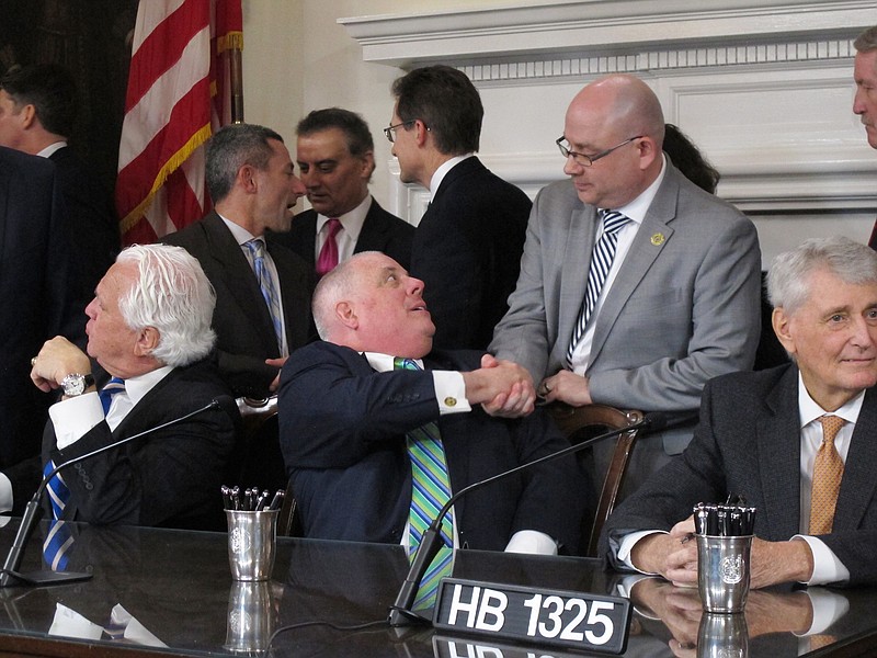 
              Maryland Gov. Larry Hogan, a Republican, shakes hands with Del. David Fraser-Hidalgo on Tuesday, April 4, 2017 in Annapolis, Maryland, after signing a bill to ban the hydraulic drilling technique known as fracking in the state. Fraser-Hidalgo, a Democrat, sponsored the bill. Maryland is the first state where a legislature has voted to bar the practice that actually has natural gas reserves. (AP Photo/Brian Witte)
            