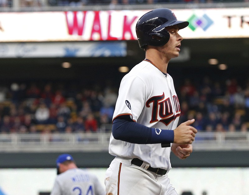 Minnesota Twins' Max Kepler heads home on a bases-loaded walk by Kansas City Royals pitcher Travis Wood, background left, during the seventh inning during a baseball game Monday, April 3, 2017 in Minneapolis. The Twins won 7-1. Wood gave up two bases loaded walks in the inning. (AP Photo/Jim Mone)