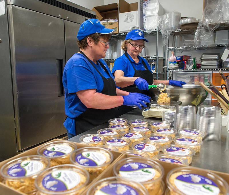 Kim Hayes and Jana Horne package pimiento cheese at The Chef and his Wife. (Photo by Mark Gilliland)