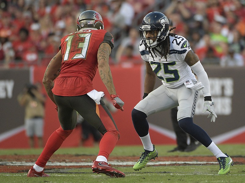 
              FILE - In this Nov. 27, 2016, file photo, Seattle Seahawks cornerback Richard Sherman (25) covers Tampa Bay Buccaneers wide receiver Mike Evans (13) during the second quarter of an NFL football game, in Tampa, Fla. Seahawks general manager John Schneider acknowledged the team has listened to trade offers regarding cornerback Richard Sherman, but downplayed that a deal may actually happen. Schneider made his comments in an interview with KIRO-AM on Wednesday, April 5, 2017. (AP Photo/Phelan Ebenhack, File)
            