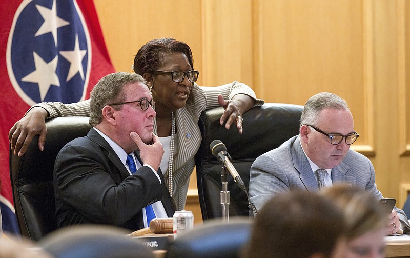 
              Rep. Gerald McCormick, R-Chattanooga, left, confers with Rep. Karen Camper, D-Memphis, before a House Finance Subcommittee in Nashville, Tenn., on Wednesday, April 5, 2017. Rep. Kevin Brooks, R-Cleveland is at right. The panel later voted to advance Republican Gov. Bill Haslam's road funding proposal that would include the state's first gas tax hike since 1989. (AP Photo/Erik Schelzig)
            