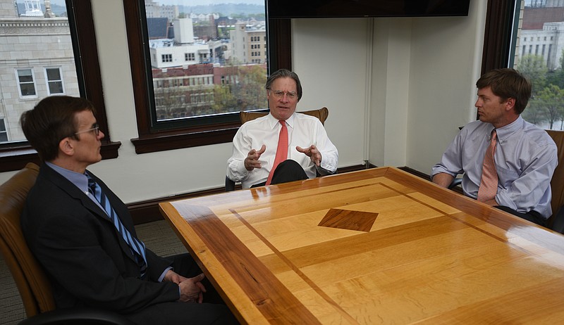 Tom Decosimo, center, speaks a Chris Hall, left, and Winston Brown listen Wednesday, April 5, 2017 at Waterhouse Public Relations.