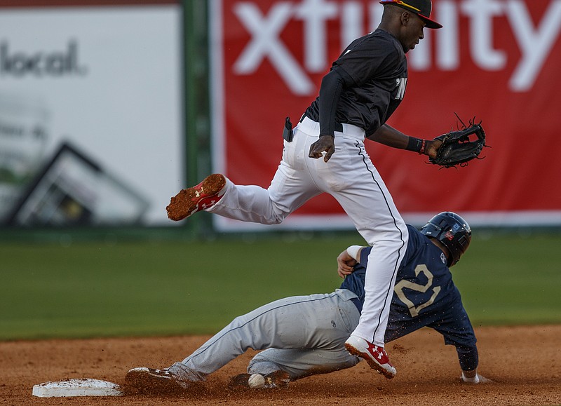Mobile runner Caleb Adams is safe at 2nd as the throw to Lookouts shortstop Nick Gordon goes wild during the Lookouts' season opener against the Mobile Bay Bears at AT&T Field on Thursday, April 6, 2017, in Chattanooga, Tenn