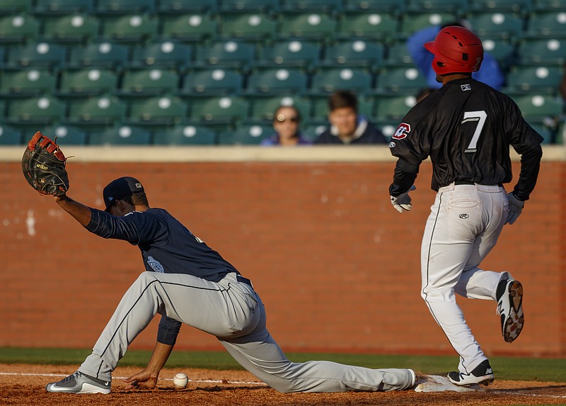 Lookouts runner Lamonte Wade is safe at 1st as Mobile 1st baseman Luis Tejada drops the throw during the Lookouts' season opener against the Mobile Bay Bears at AT&T Field on Thursday, April 6, 2017, in Chattanooga, Tenn