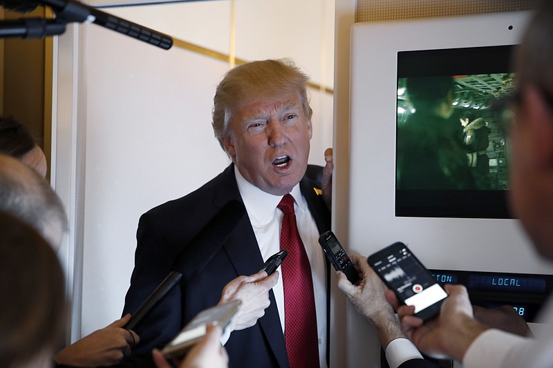 
              President Donald Trump speaks with reporters on Air Force One while in flight from Andrews Air Force Base, Md., to Palm Beach International Airport, Fla., Thursday, April 6, 2017. (AP Photo/Alex Brandon)
            