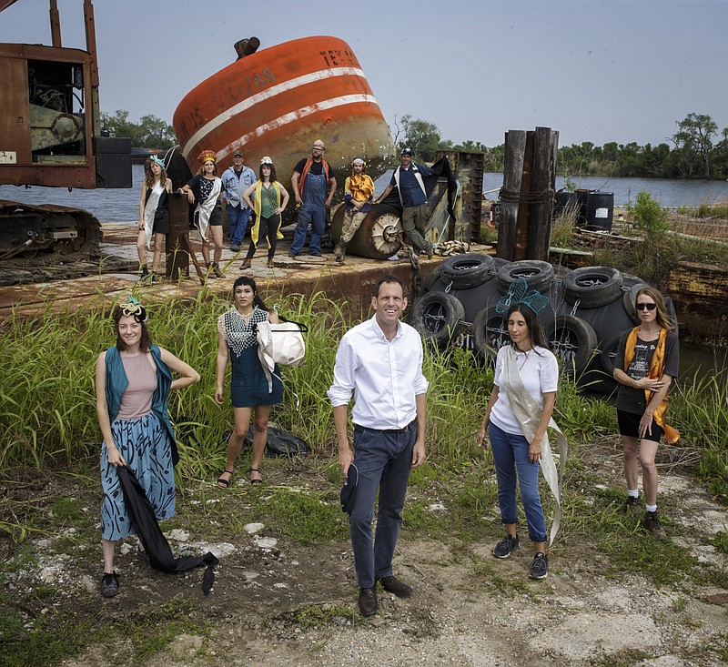 
              In this Wednesday, April 5, 2017 photo, fabrication, art and costume departments for the "New Water Music" performance pose on the barge along with Delaney Martin of New Orleans Airlift and composer Yotam Haber on Bayou Sauvage in New Orleans. "New Water Music" features composer Yotam Haber on a floating barge with the Louisiana Philharmonic Orchestra and visual presentations by New Orleans Airlift arts collective. (Sophia Germer /The Advocate via AP)
            