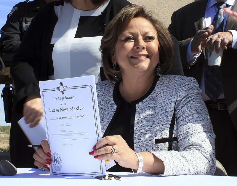 
              New Mexico Gov. Susana Martinez holds signed legislation that expands access to the overdose antidote naloxone during a ceremony at a substance abuse treatment center for youth in Albuquerque, N.M., on Thursday, April 6, 2017. With the signing, New Mexico becomes the first state to require all state and local law enforcement officers to be equipped with naloxone. The measure also requires treatment clinics to educate their patients and provide two doses of naloxone and a prescription for the overdose-reversal drug. (AP Photo/Susan Montoya Bryan)
            