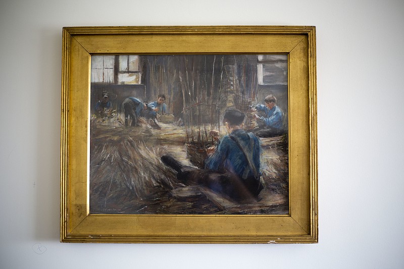 
              In this photo taken on Wednesday, April 5, 2017, Max Liebermann's "Basket Weavers" painting hangs in a law office in Jerusalem. Max Liebermann's "Basket Weavers" painting is returning to the American heirs of its original Jewish owner, after it was confiscated by the Nazis, jockeyed by an unscrupulous German art trader and ultimately purchased by an Israeli Holocaust survivor unaware of its murky past. (AP Photo/Ariel Schalit)
            