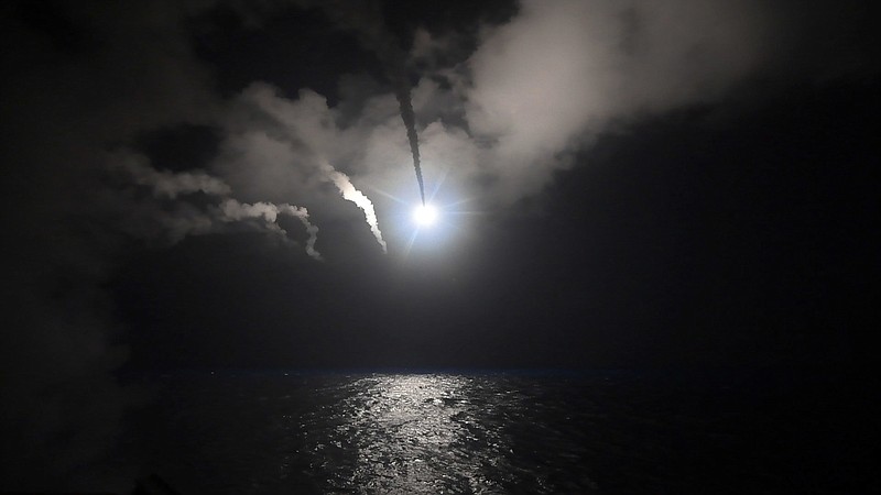 In this image provided by the U.S. Navy, the guided-missile destroyer USS Porter (DDG 78) launches a tomahawk land attack missile in the Mediterranean Sea, Friday, April 7, 2017. The United States blasted a Syrian air base with a barrage of cruise missiles in fiery retaliation for this week's gruesome chemical weapons attack against civilians. (Mass Communication Specialist 3rd Class Ford Williams/U.S. Navy via AP)