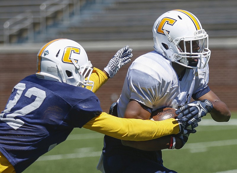 UTC wide receiver Bingo Morton, right, tries to break through defensive back Elijah Pankey during UTC's spring football game day at Finley Stadium on Saturday, April 8, 2017, in Chattanooga, Tenn. This year's spring game was an open practice followed by a 40 minute scrimmage.