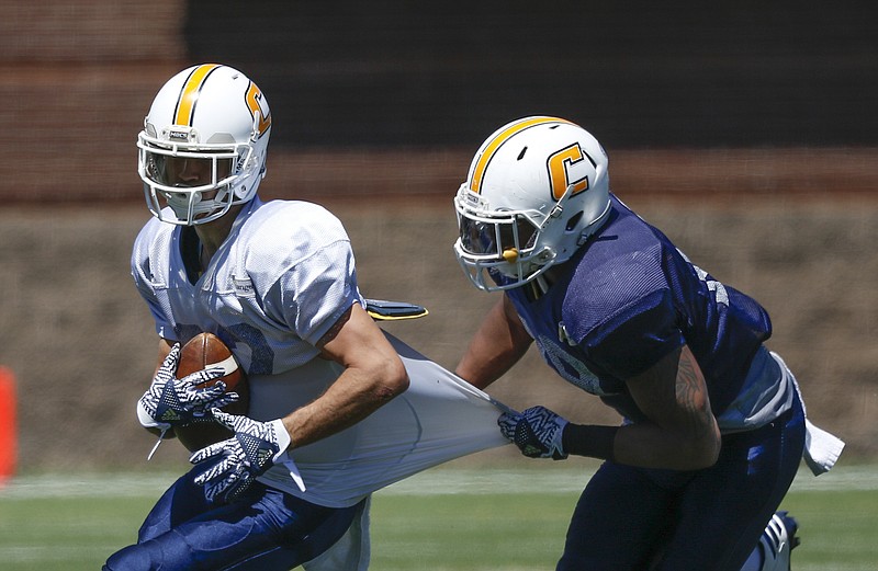 UTC linebacker Tae Davis works to bring down wide receiver Kota Nix during Saturday's spring game at Finley Stadium. The Mocs will practice three more times before closing their first spring under coach Tom Arth.