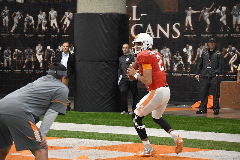 Redshirt freshman quarterback Jarrett Guarantano goes through a drill at Tennessee's football practice on April 6, 2017. Quarterbacks coach Mike Canales looks on.