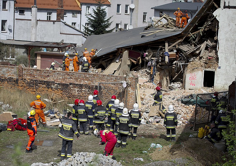 
              Rescuers and firefighters search for 11 missing people in the rubble of an apartment house that collapsed in Swiebodzice, Poland, on Saturday, April 8, 2017. Firefighters suspect the collapse might have been caused by a gas explosion. Several people were killed and injured. (AP Photo)
            