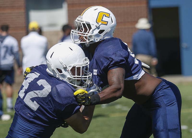UTC outside linebacker Josh Phillips, right, runs a drill with Hawk Schrider during UTC's spring football showcase Saturday at Finley Stadium. Phillips played three seasons of basketball at MTSU before suiting up for football with the Mocs last year.