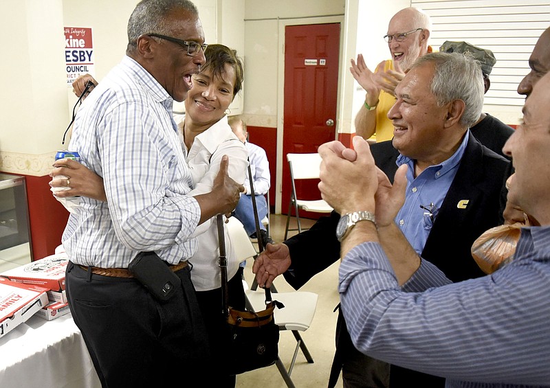 Erskine Oglesby is embraced by his wife Sheryl has supporters celebrate his victory over incumbent Chris Anderson in the runoff election for District 7 at the campaign's headquarters in Alton Park.  Erskine Oglesby won the runoff election from District 7 on April 11, 2017.  