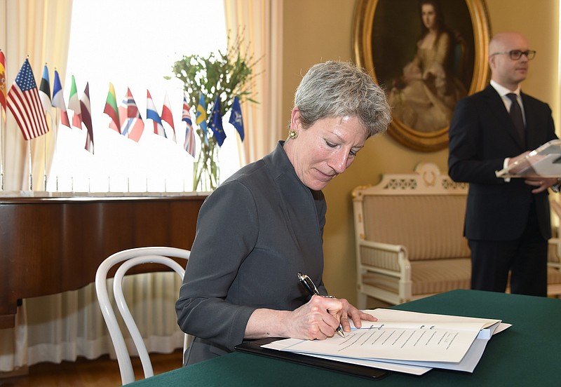 
              Foreign Service Officer Donna Welton from the US, signs the Memorandum of Understanding in Helsinki, Finland, Tuesday, April 11, 2017. A group of European Union and NATO nations have agreed to establish a European "hybrid threat" center in Finland to combat unconventional methods of warfare such as disinformation and fake news. (Markku Ulander/Lehtikuva via AP)
            