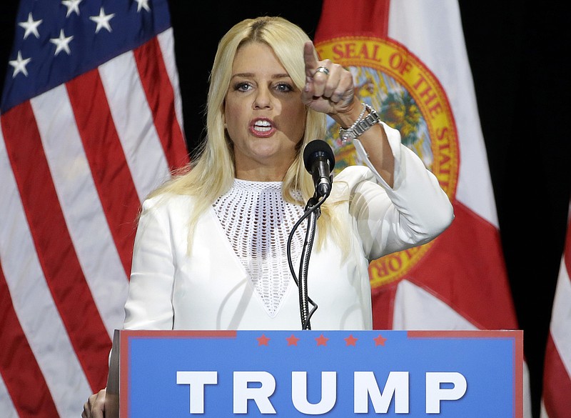 In this June 11, 2016 file photo, Florida Attorney General Pam Bondi gestures as he speaks to supporters of then-Republican presidential candidate Donald Trump during a rally in Tampa, Fla. Carlos G. Muniz, a former top aide Pam Bondi involved in her office's decision not to pursue legal action against Trump University has been chosen to serve as the top lawyer at the Education Department. (AP Photo/Chris O'Meara, File)