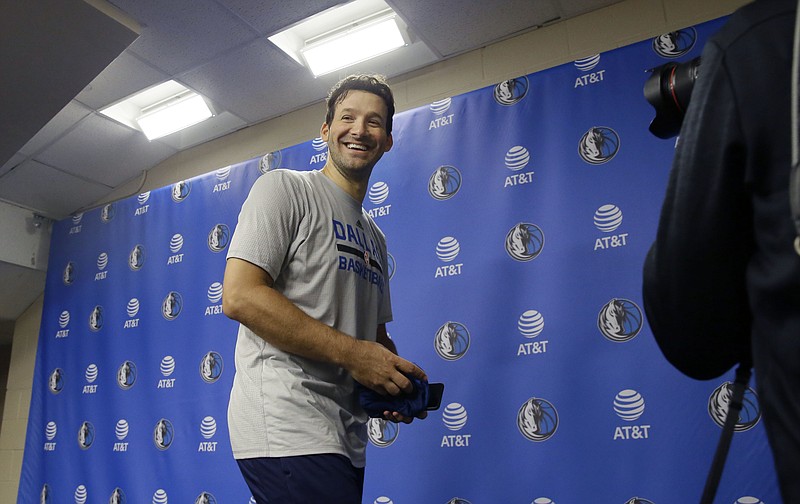 
              Former Dallas Cowboys quarterback Tony Romo smiles as he leaves a news conference after an NBA basketball shoot around in Dallas, Tuesday, April 11, 2017. Romo will be a Maverick for day and ride the bench during a home finale game featuring two teams that failed to make the playoffs this year. (AP Photo/LM Otero)
            