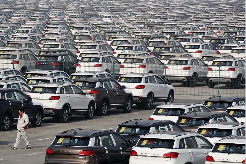 
              In this Sunday, Feb. 19, 2017 photo, a worker walks past Haval SUV models parked outside the Great Wall Motors assembly plant in Baoding in north China's Hebei province. China's auto sales growth plunged in March as demand for SUVs weakened and purchases of sedans contracted, an industry group reported Tuesday, April 11, 2017. (AP Photo/Andy Wong)
            