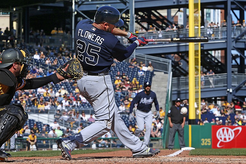 Atlanta Braves' Tyler Flowers (25) drives in a run from third with a fielder's choice to Pittsburgh Pirates third baseman Adam Frazier in the tenth inning of a baseball game in Pittsburgh, Sunday, April 9, 2017. The Pirates won in ten innings 6-5. (AP Photo/Gene J. Puskar)