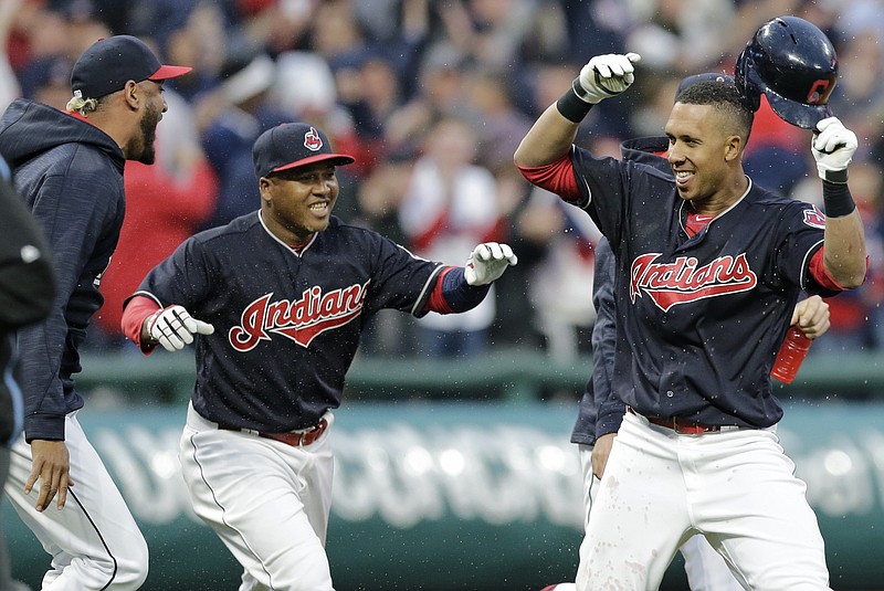 
              Cleveland Indians' Michael Brantley, right, is welcomed by teammates after Brantley hit an RBI double off Chicago White Sox relief pitcher Tommy Kahnle during the 10th inning of a baseball game, Tuesday, April 11, 2017, during opening day in Cleveland. Francisco Lindor scored on the play. The Indians won 2-1. (AP Photo/Tony Dejak)
            