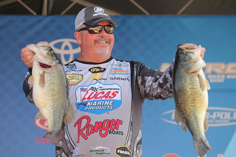 Spring City resident John Murray shows off his two big bass from Saturday's collection that helped propel him to the Bassmaster Elite tournament victory Sunday in Louisiana. He earned $100,000 for his four-day haul of 77 pounds, 10 ounces.