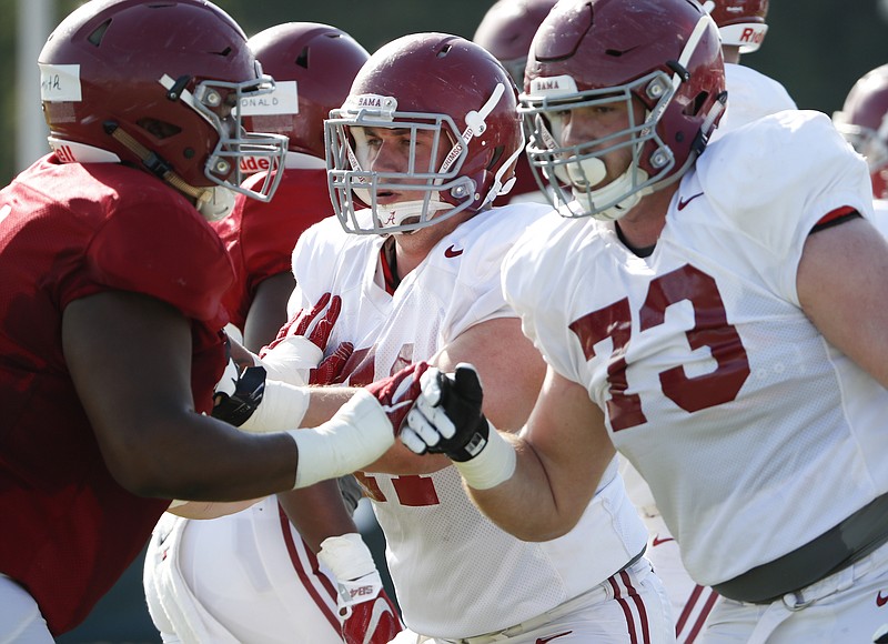 Alabama's Jonah Williams (73) has flipped from right to left tackle this spring, where he is working alongside left guard Ross Pierschbacher, middle.