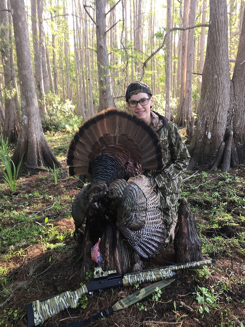 Jack Ellis shows off a gobbler he shot in Florida. You'll probably have to alter your typical plan when taking a young turkey hunter into the woods, but the effort is worth it, writes outdoors columnist Larry Case.