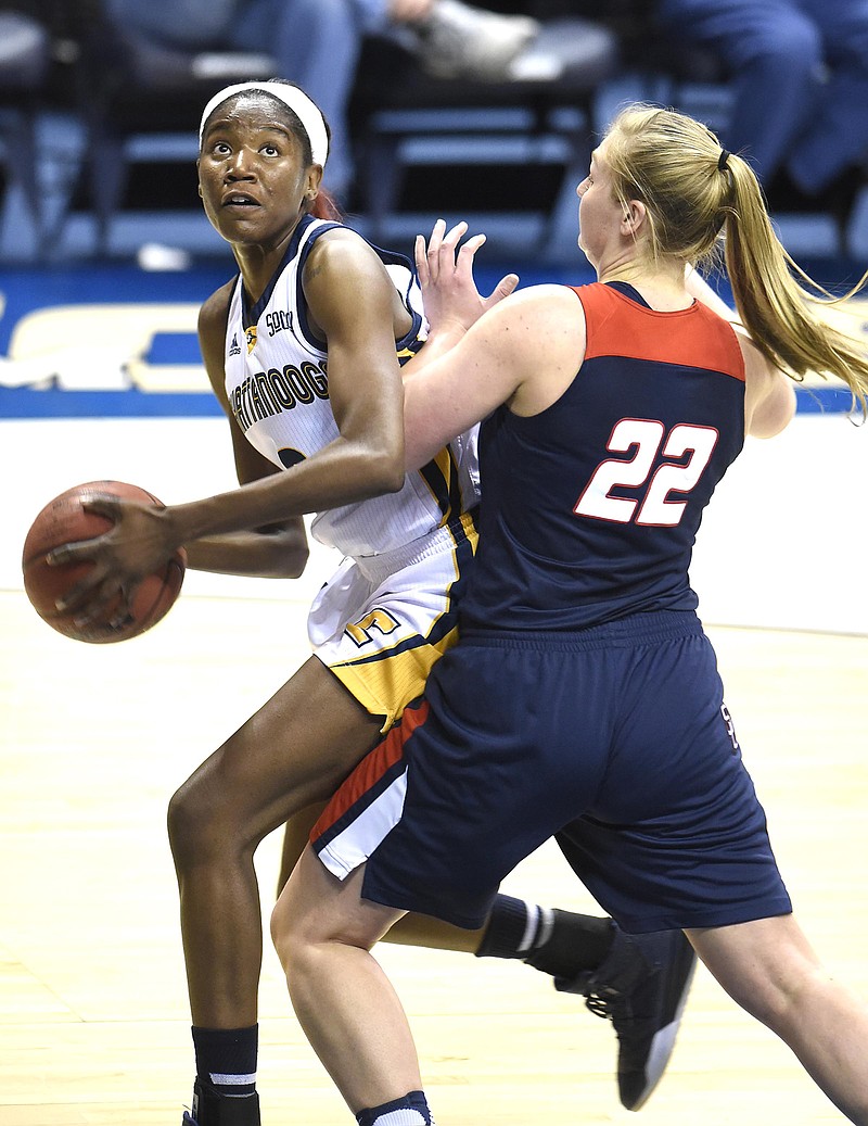 UTC's Jasmine Joyner looks toward the basket while being guarded by Samford's Ellen Riggins during a game at McKenzie Arena in February.