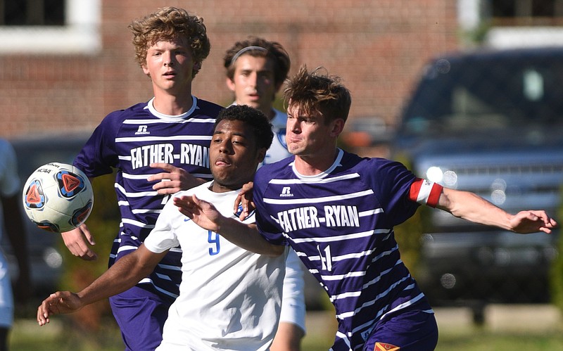 McCallie's Andre Roberts and Father Ryan's Ethan Wilson, left, and John Armbruster pursue the ball Wednesday, April 12, 2017 at McCallie.