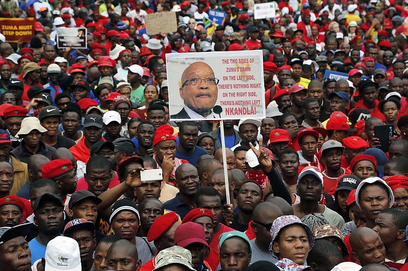 
              Opposition political parties gather on the lawns of the Government Union Buildings in Pretoria, South Africa, Wednesday, April 12, 2017. Thousands of South Africans on Wednesday marked the 75th birthday of President Jacob Zuma with a protest against him, pushing for his resignation because of scandals and his dismissal of a widely respected finance minister. (AP Photo/Denis Farrell)
            