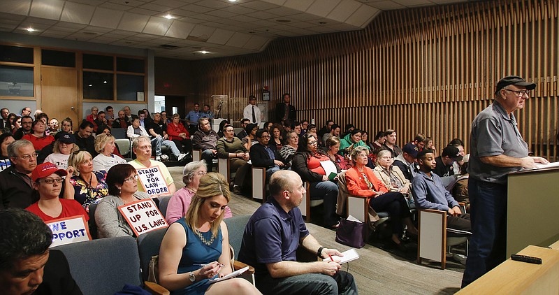 
              People crowd the Lansing City Council chambers for a special meeting in Lansing, Mich., Wednesday, April 12, 2017. Michigan's capital city on Wednesday rescinded its decision to deem itself a "sanctuary city" protecting immigrants, bowing to concerns from the business community that the ambiguous, contentious term may draw unwanted attention to Lansing. (Matthew Dae Smith/Lansing State Journal via AP)
            