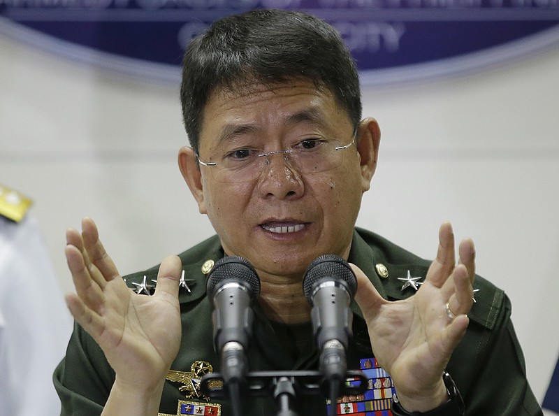 
              Philippine military chief of staff Gen. Eduardo Ano gestures during a press conference at Camp Aguinaldo, the military headquarters in Quezon city, north of Manila, Philippines Wednesday, April 12, 2017. Philippine troops battling militants in a central province killed a key Abu Sayyaf commander who had been blamed for the beheadings of two Canadians and a German hostage and was apparently attempting another kidnapping mission, Ano said Wednesday. (AP Photo/Aaron Favila)
            