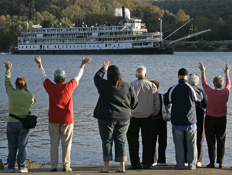 ** FILE ** In this Oct. 21, 2008 file photo people gather at the Anderson Ferry to view the riverboat Delta Queen, as it moves up the Ohio River past Cincinnati. (AP Photo/Al Behrman, File)
