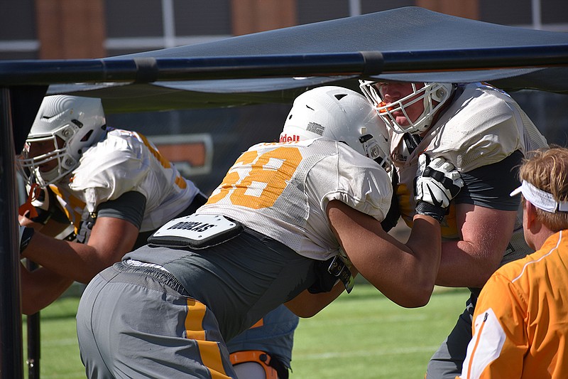 Tennessee offensive lineman Marcus Tatum, left, blocks a teammate during a drill at practice Thursday in Knoxville.
