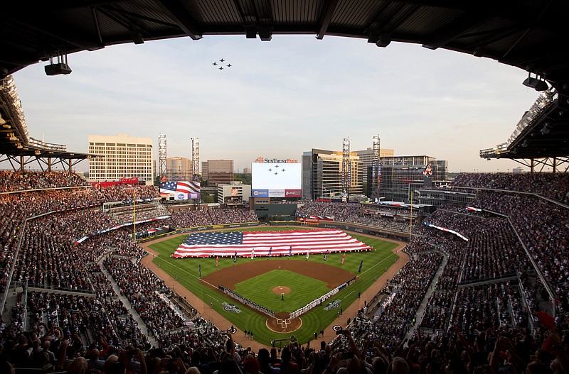 
              U.S. Navy fighter jets fly over SunTrust Park during the national anthem before a baseball game between the Atlanta Braves and the San Diego Padres in Atlanta, Friday, April 14, 2017. This isn't just another opening day in Atlanta. The Braves are playing their first regular-season game in SunTrust Park, the new stadium that replaced Turner Field. (AP Photo/David Goldman)
            