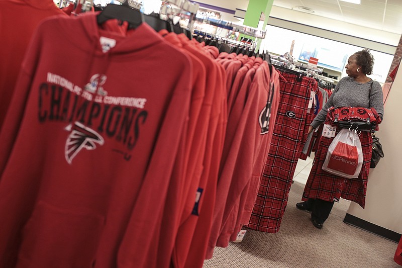 
              In this Friday, March 17, 2017, photo, Patricia Crawford shops for Atlanta Falcons and University of Georgia clothing at a J.C. Penney store in the Georgia Square Mall in Athens, Ga. On Friday, April 14, 2017, the Commerce Department reports on business stockpiles in February. (John Roark/Athens Banner-Herald via AP)
            