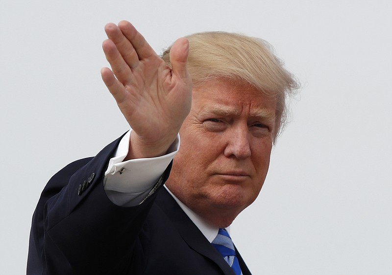 
              President Donald Trump waves as he boards Air Force One before his departure from Andrews Air Force Base, Md., Thursday, April 13, 2017, to his Mar-a-Largo resort in Florida. (AP Photo/Alex Brandon)
            