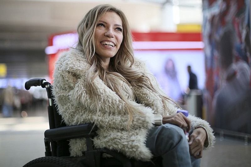 
              FILE - In this file photo dated Tuesday, March 14, 2017, Russian singer Yulia Samoylova who was chosen to represent Russia in the 2017 Eurovision Song Contest, poses while sitting in a wheelchair at Sheremetyevo airport outside Moscow, Russia.   Russia's Channel One says it will not broadcast the Eurovision Song Contest in Russia after Ukraine, which hosts the contest this year, has barred the Russian entrant from traveling to the country. (AP Photo/Maria Antipina, FILE)
            
