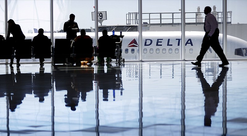 
              FILE - In this Thursday, Oct. 13, 2016, file photo, a Delta Air Lines jet sits at a gate at Hartsfield-Jackson Atlanta International Airport, in Atlanta. Delta is giving airport employees permission to offer passengers up to almost $10,000 in compensation to give up their seats on overbooked flights. Delta's move comes as United Airlines struggles to recover from images of a passenger's forced removal from a sold-out flight. (AP Photo/David Goldman, File)
            