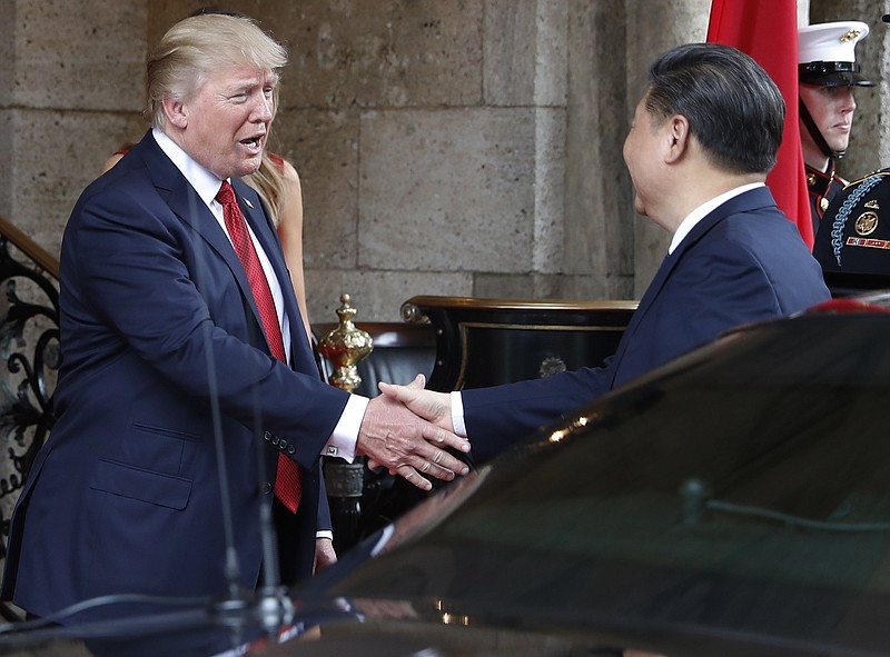 
              FILE - In this Thursday, April 6, 2017, file photo, President Donald Trump shakes hands with Chinese President Xi Jinping as he arrives before dinner at Mar-a-Lago resort, in Palm Beach, Fla. In recent weeks, Trump has moved away from his tough campaign rhetoric on trade. Trump's threat to slap harsh tariffs on Chinese goods has given way to a bid to mend fences with Beijing. (AP Photo/Alex Brandon, File)
            
