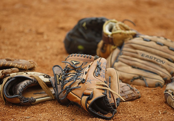 Staff Photo by Doug Strickland/Chattanooga Times Free Press - Gloves lie in a pile in the Lady Trojan Invitational softball tournament Friday, March 29, 2013, in Soddy-Daisy, Tenn.