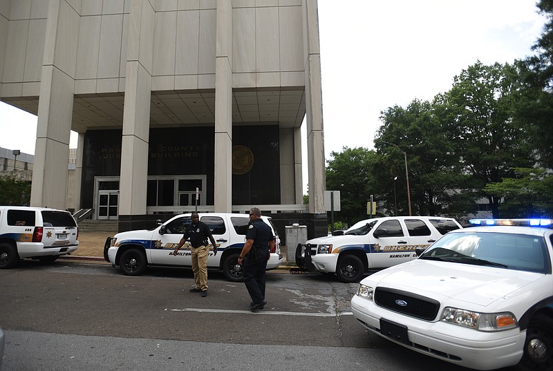 Police vehicles line the street Wednesday, June 15, 2016, outside of the Hamilton County Jail.