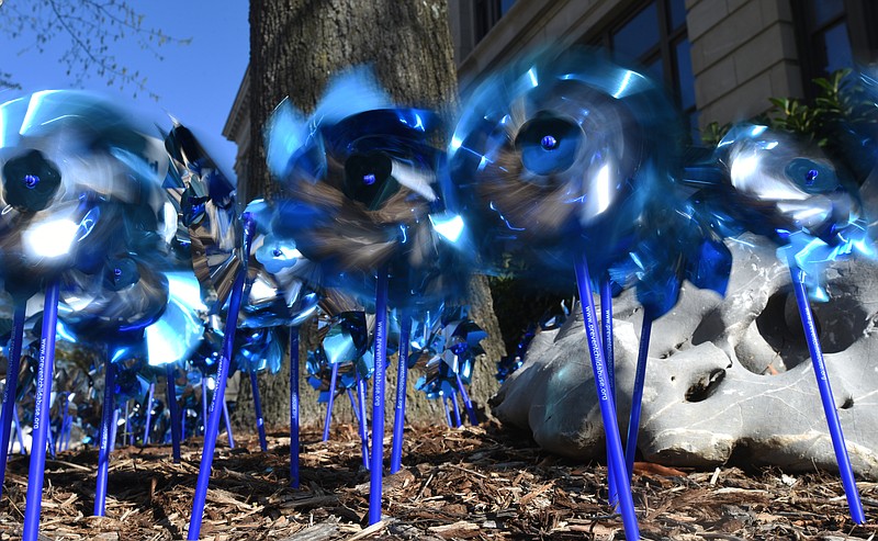 Blue pinwheels spin outside Chattanooga City Hall on April 7 to raise awareness of child abuse. April is child abuse prevention and awareness month.