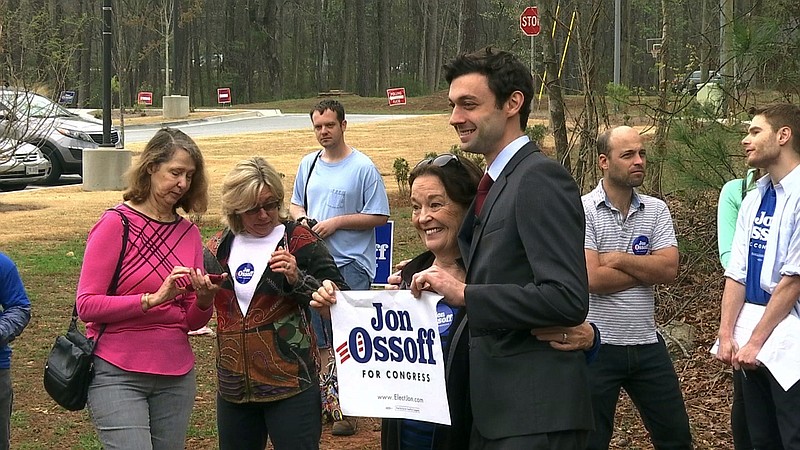 
              This March 27, 2017 photo shows Democratic congressional candidate Jon Ossoff with supporters outside of the East Roswell Branch Library in Roswell, Ga.  Five Democrats will appear on the ballot, but Ossoff is considered the greatest threat to the GOP. Two independent candidates also are running. (AP Photo/Alex Sanz)
            