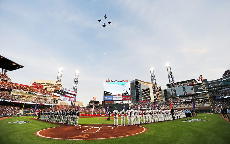 United States Navy fighter jets fly over SunTrust Park during the national anthem before a baseball game between the Atlanta Braves and the San Diego Padres in Atlanta, Friday, April 14, 2017. The Braves are playing their first regular-season game in SunTrust Park, the new suburban stadium that replaced Turner Field. (AP Photo/John Bazemore)

